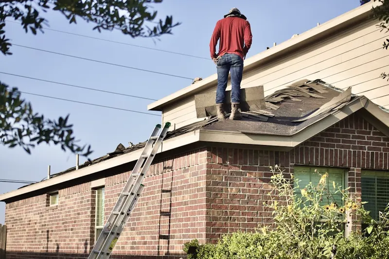 Professional roofer working on a residential roof in Normandy Estates